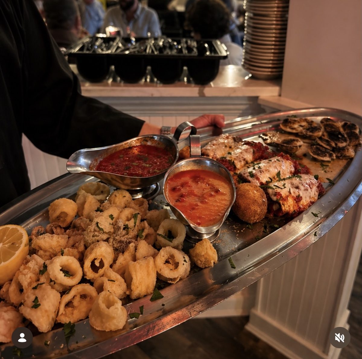 An antipasto tray carried to the table